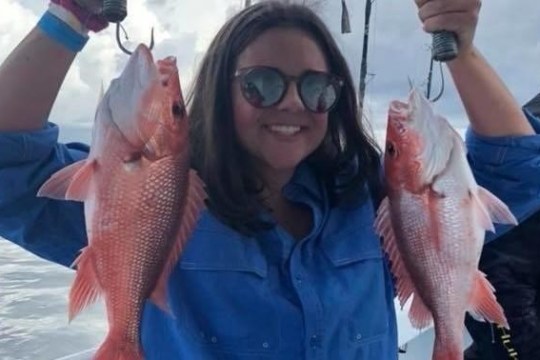 a person holding a fish