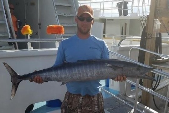 a man holding a fish